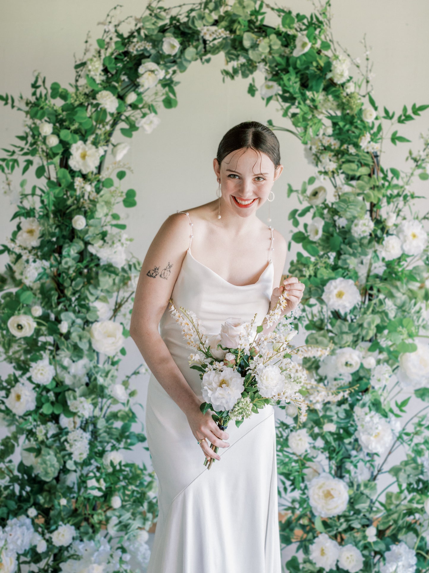 Bride with Silk bouquet and White Arch